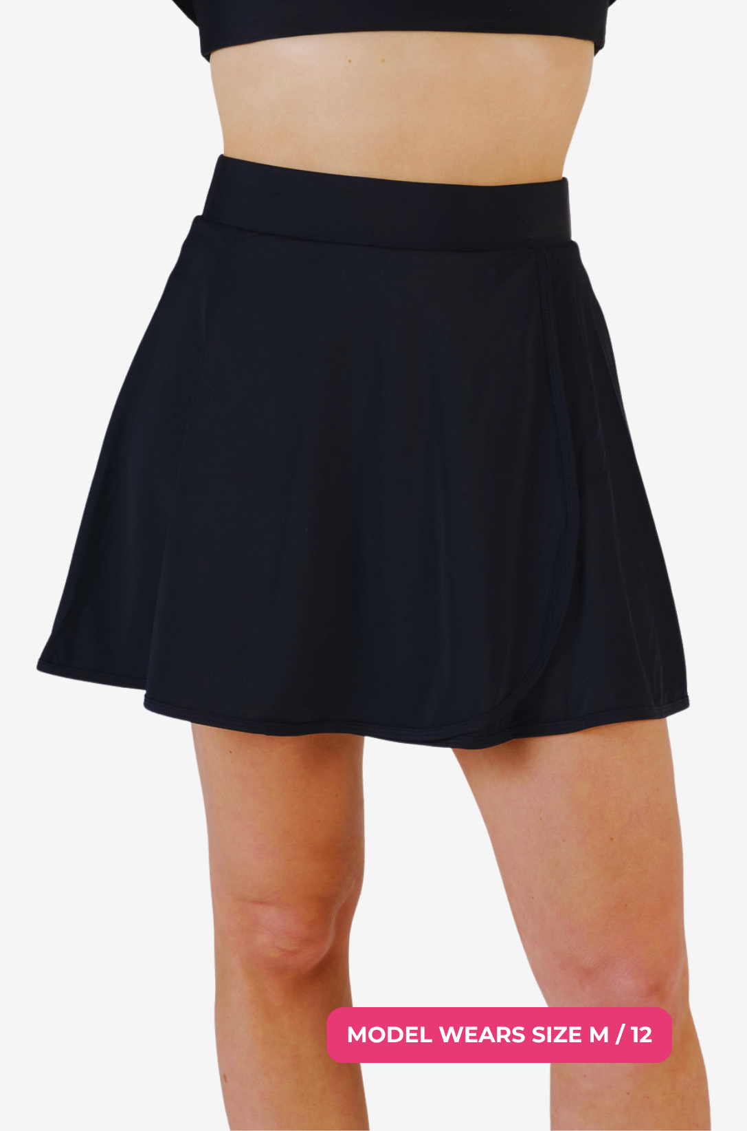 Black high-waisted swim skirt worn by a model size M/12 on a grey background