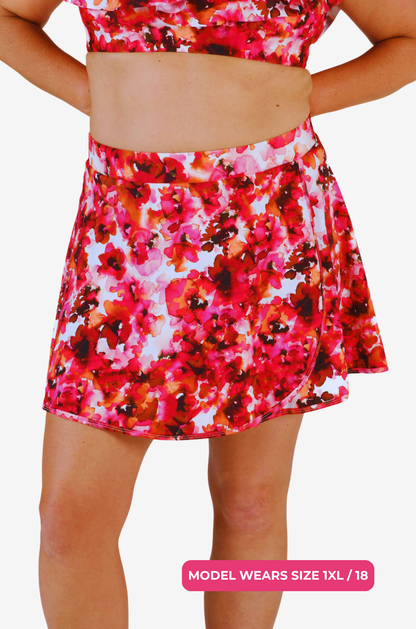 Floral high-waisted swim skirt worn by a size 1XL/18 model on a grey background