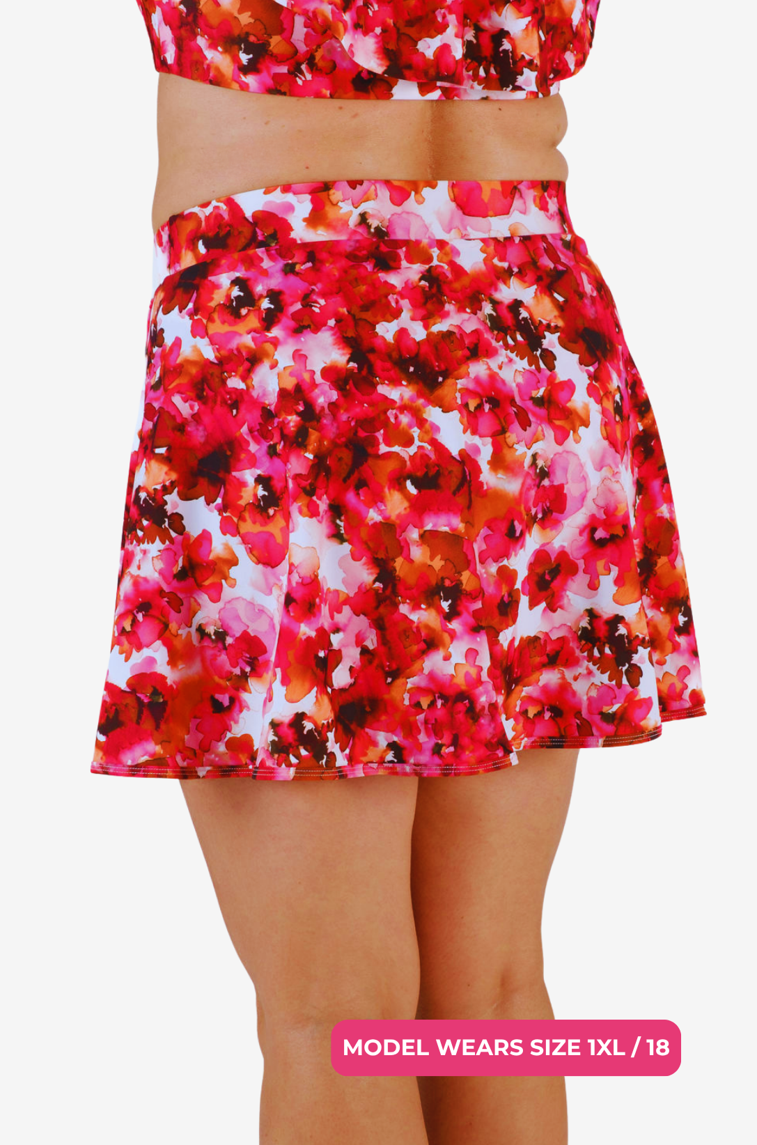 Side back view of a floral high-waisted swim skirt worn by a model size 1XL/18 on a grey background