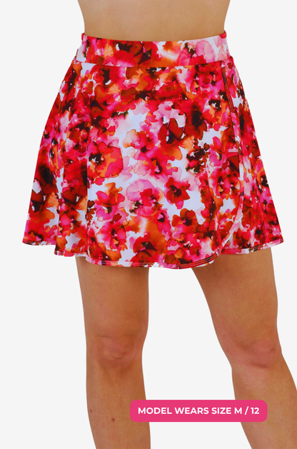 Floral patterned high-waisted swim skirt worn by a model size M/12 on a grey background