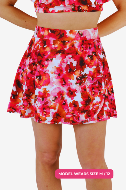 Floral high-waisted swim skirt with a size M/12 model wearing it on a grey background