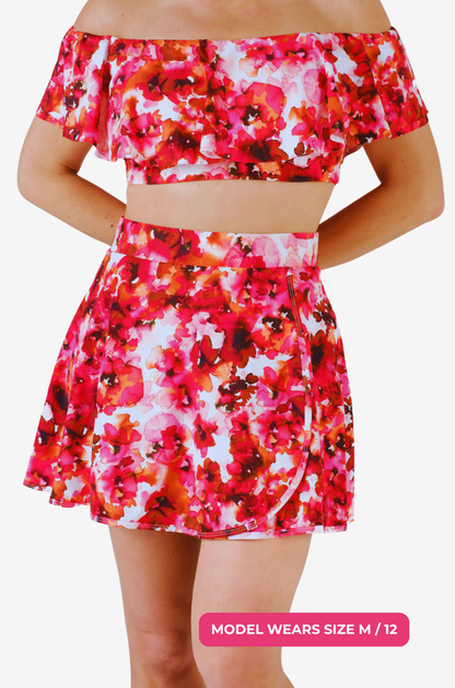Floral two-piece swimsuit with a high-waisted swim skirt and matching top on a model size M/12 on a grey background