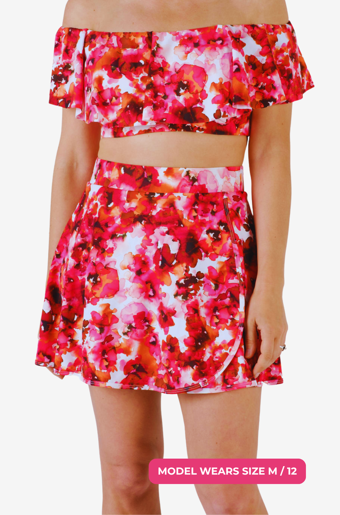 Floral high-waisted swim skirt and matching top worn by a size M/12 model on a grey background