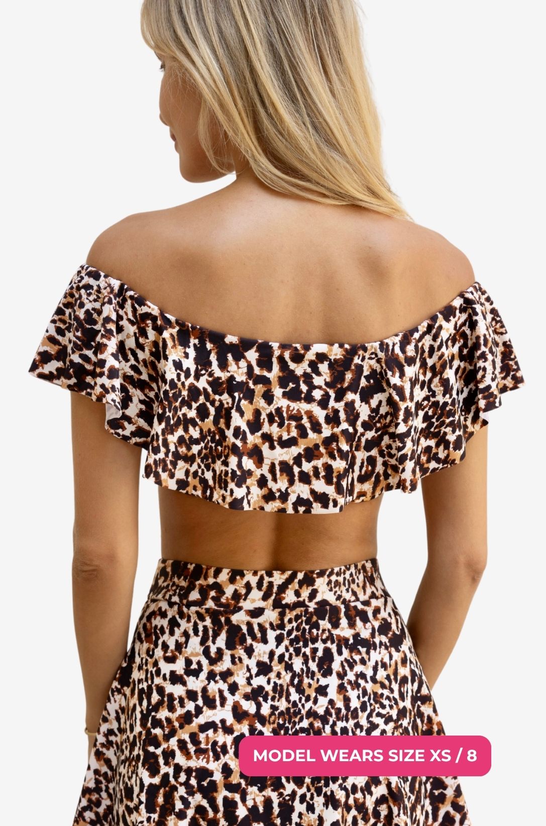 Back view of a model size XS/8 wearing an off-shoulder swim top in leopard print