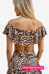 Back view of a model size XS/8 wearing an off-shoulder swim top in leopard print