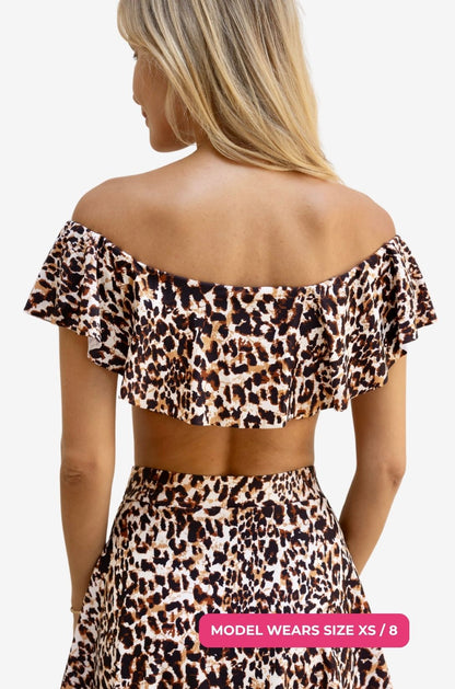 Back view of a model size XS/8 wearing an off-shoulder swim top in leopard print