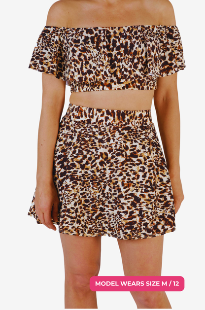 Leopard print high-waisted swim skirt worn by a size M/12 model on a grey background