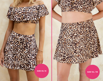 Leopard print high-waisted swim skirt and off-shoulder swim top set with size XS/8 and 1XL/18 labels on a plain background